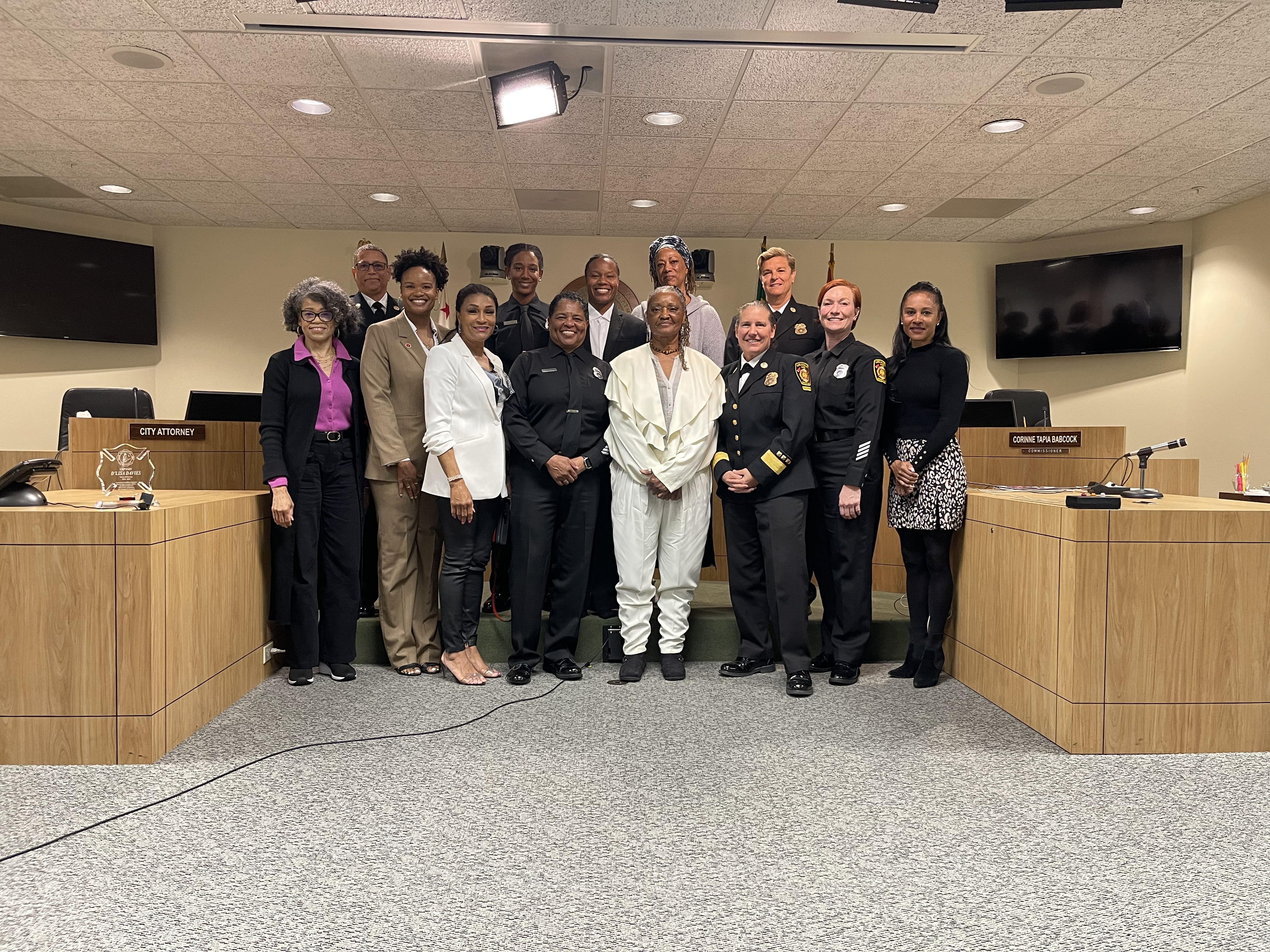 Group shot of d'Lisa Davies and others at the Commission meeting, including Chief Crowley